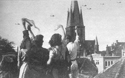 Dutch civilians waving up at low-flying bombers